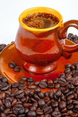 Cup of hot coffee with coffee grains