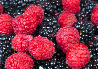Raspberry and blackberry berries close up