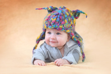 Joyful baby in a funny hat knitted