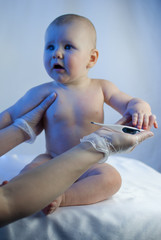 Doctor measure temperature of newborn baby
