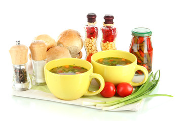 Fragrant soup in cups isolated on white
