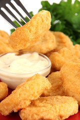 Fried chicken nuggets with vegetables and sauce isolated