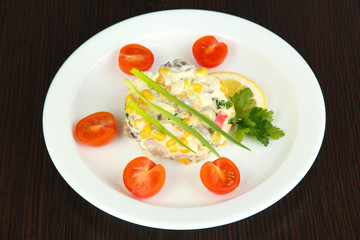 Small portion of food on big plate on wooden table