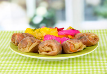 Stuffed cabbage rolls on table in room
