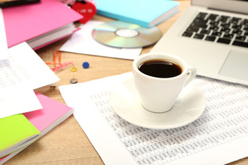 Cup of coffee on office desktop close-up