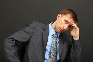 Young businessman ton black background