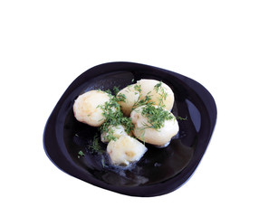 Potatoes on a black plate.