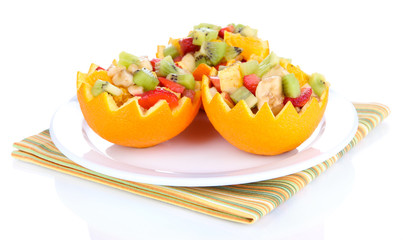 Fruit salad in hollowed-out orange isolated on white