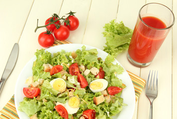 Caesar salad on blue plate, on color wooden background