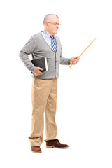Full length portrait of a male teacher holding a wand and a book