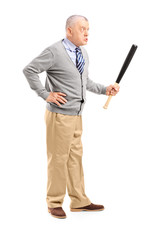 Full length portrait of an angry middle aged man holding a baseb