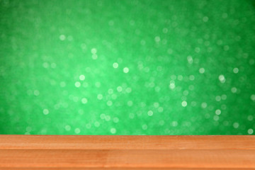 Wooden table on green background