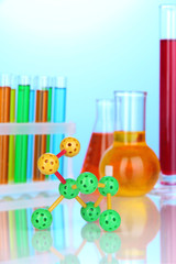 Molecule model and test tubes with colorful liquids
