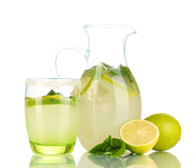 Lemonade in pitcher and glass isolated on white