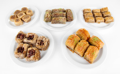 Sweet baklava on plates isolated on white