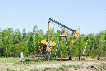 oil pump works on spring forest background