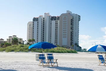 Wall murals Clearwater Beach, Florida beach with deck chair near to buildings in a sunny morning