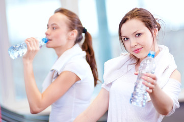 Women drinking water after sports