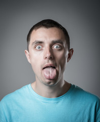 Fototapeta premium young man shows tongue