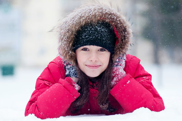 Happy young woman plays with a snow