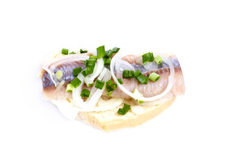 Sandwiches with herring, onions and herbs on white background