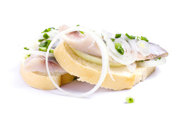 Sandwiches with herring and herbs on white background