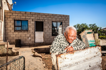 Man in front of his township house - obrazy, fototapety, plakaty