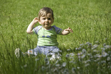 toddler standing on green grass