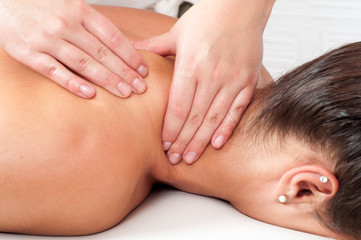 Obraz na płótnie Canvas Young woman getting massage in massage salon