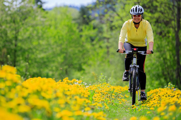 Bike riding - woman on bike, active adult concept