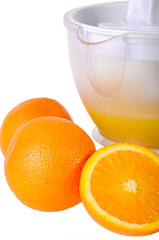 Still life with a juice extractor and oranges