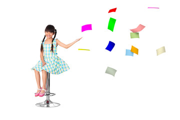Little asian girl with a lot of flying papers