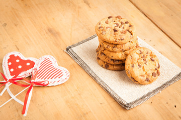 Chocolate biscuits with two hearts, wooden background