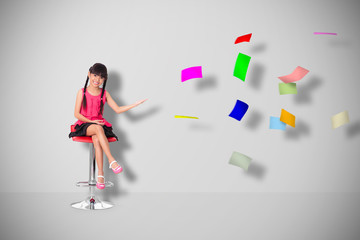Little asian girl with a lot of flying papers