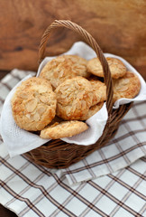 Oatmeal cookies with almond in a basket on a wooden background
