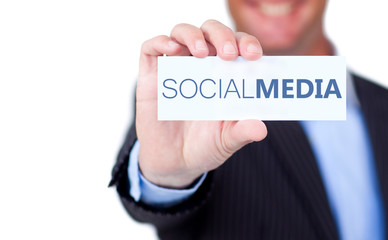 Businessman holding a label with social media written on it
