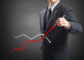 Businessman drawing a growth graph