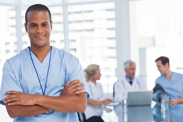 Fototapeta premium Smiling doctor with arms crossed