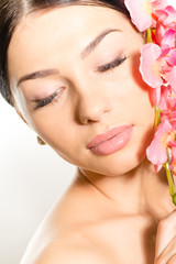Beautiful girl face with eyes closed & pink flowers