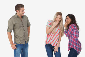 Girls laughing about secrets and leaving man out