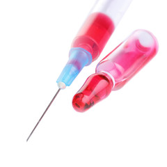 Syringe and ampoule with red liquid on white