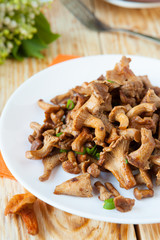 roasted chanterelle mushrooms on a white plate