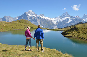 Travelers enjoying Alpine panorama. Jungfrau region, Switzerland