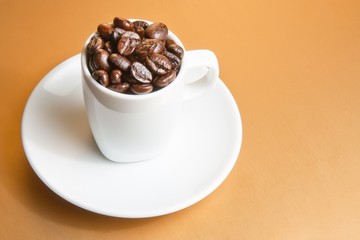 white cup with coffee beans with space for text