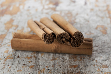 Cinnamon scrolls on a distressed wood background.