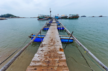 Old pontoon beside the sea,the bridge towards faraway © hxdyl