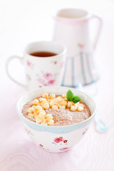 Oatmeal porridge with banana and flax seed, selective focus