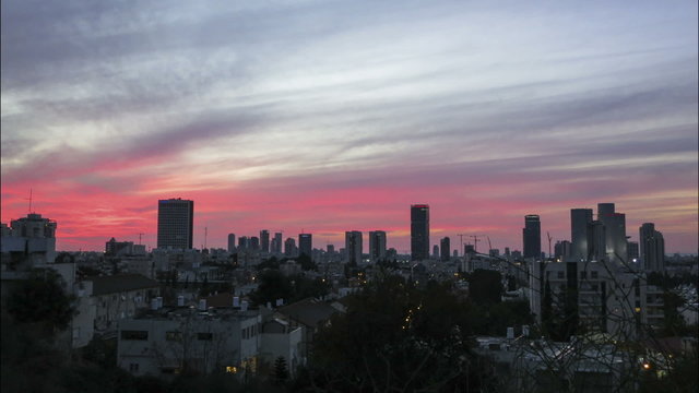 Tel Aviv City skyline time lapse orange sunset into night