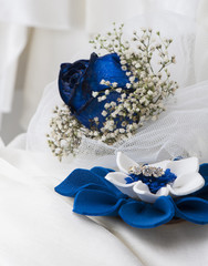 a  blue roses and wedding rings