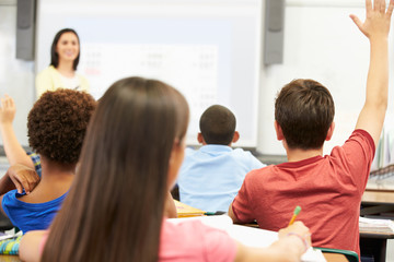 Fototapeta premium Teacher Standing In Front Of Class Asking Question